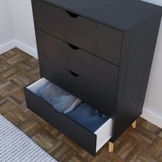 a black dresser with two drawers on top of it