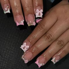 a woman's hands with pink and white french manies decorated with bows on them