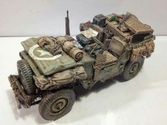 a toy army vehicle is shown on a white surface