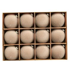 twelve white balls in a wooden box with diamond decorations on the top and bottom side