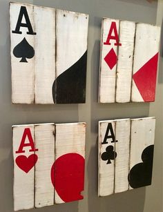 four pieces of art made out of wood with playing cards painted on the back and sides