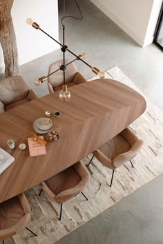 an overhead view of a dining table and chairs