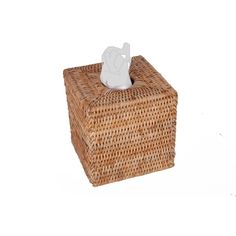 a tissue dispenser sitting on top of a wicker box