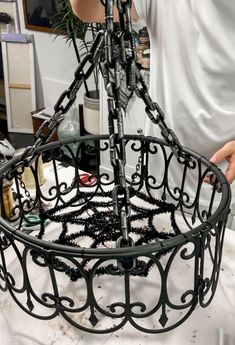 a man is working on an ornate metal basket