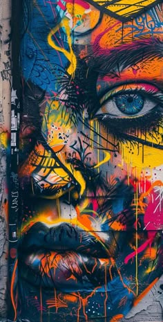 the face and eyes of a woman painted on a wall with colorful spray paint splattered all over it