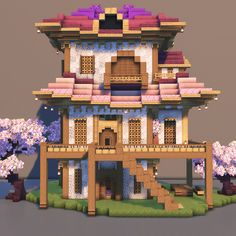 a house made out of paper with trees in the front and purple flowers on the outside