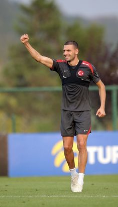 a man is running on the field with his arm in the air