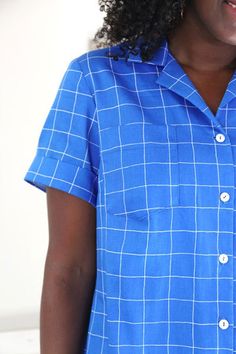 a woman with curly hair wearing a blue shirt