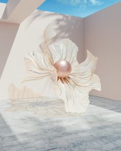 a white flower is in the middle of a room with blue sky and clouds behind it