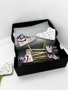 a pair of sneakers are sitting in a shoe box next to a hairbrush and comb