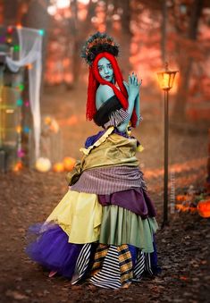 a woman dressed in costume standing next to a lamp post