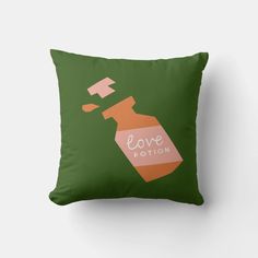 a green pillow with an orange liquid bottle and the words love potton on it