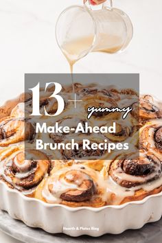 cinnamon buns being drizzled with icing on top of a cake