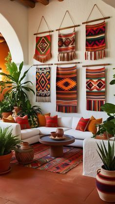 a living room filled with lots of furniture and potted plants on top of it