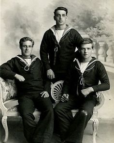 an old black and white photo of three men in sailor's outfits sitting on a bench