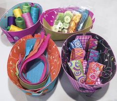 three baskets filled with different types of sewing supplies