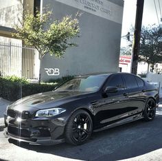 a black car parked in front of a building