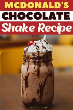 a chocolate shake in a mason jar with whipped cream and cherries on the top