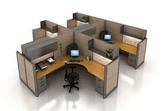 an office cubicle with four desks and two monitors