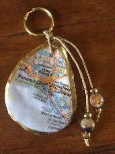 a keychain with a map on it and some beads hanging from the end