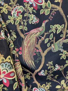 the fabric is very colorful and has a bird on it's back, as well as flowers