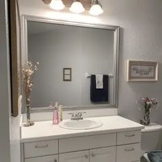 a bathroom with a sink, mirror and toilet