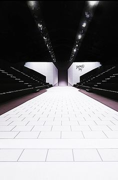 an empty stage with white tiles on the floor