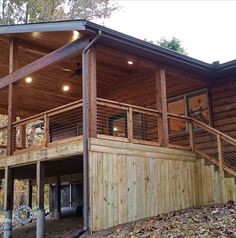 a large wooden house sitting on top of a hill