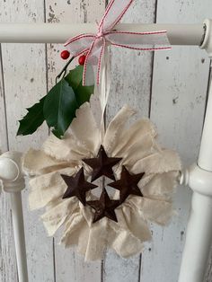 a christmas decoration hanging from the side of a white chair