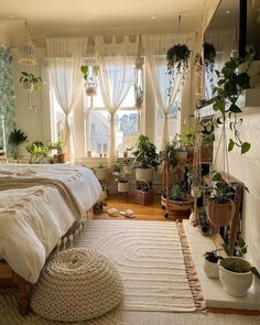 a bed room with a neatly made bed and lots of plants