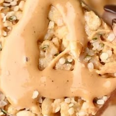 a close up view of some kind of food with peanut butter on top and peanuts in the middle