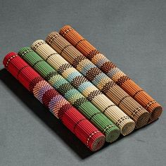 a stack of multicolored crochet knitting needles sitting on top of each other