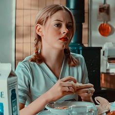 a woman sitting at a table with food in front of her