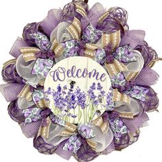 a purple and white welcome wreath with lavender flowers