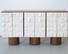 three white and brown sideboards with wooden bases