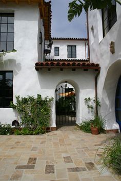 an entrance to a white house with blue door and window panes on the side