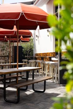 an outdoor dining area with tables and umbrellas