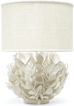 a table lamp with white flowers on it