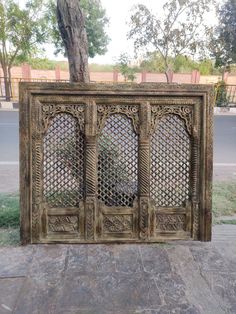 an old wooden gate sitting next to a tree