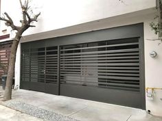 an image of a garage door with blinds on the front and side doors in grey