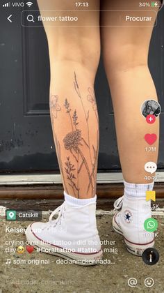 a person with tattoos on their legs standing in front of a door