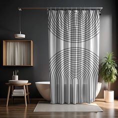 a bathroom with a bathtub, toilet and shower curtain in black and white colors