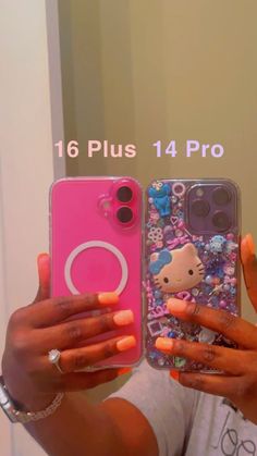 a woman holding up two cell phones with hello kitty cases on the front and back