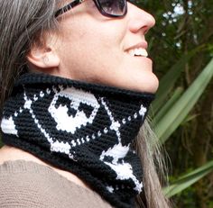 a woman wearing a black and white cowgirl neck scarf