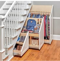 an under the stairs storage area with shoes and bags