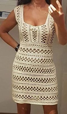 a woman in a white crochet dress is taking a selfie with her cell phone