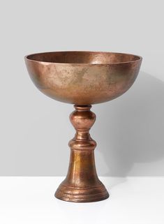 a large metal bowl sitting on top of a table