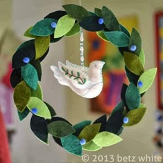 an ornament with leaves and a bird hanging from it