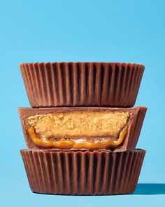 three chocolate cupcakes stacked on top of each other with peanut butter in the middle