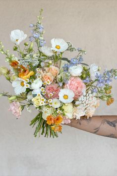 an arm with a hummingbird tattoo is holding a big bouquet of pastel and white flowers in front of a light grey wall Wildflower Bouquet, Pastel Wedding, Bouquet Of Flowers, Wedding Mood, Wedding Vibes, Flower Bouquet Wedding, Wedding Florals, Backyard Wedding